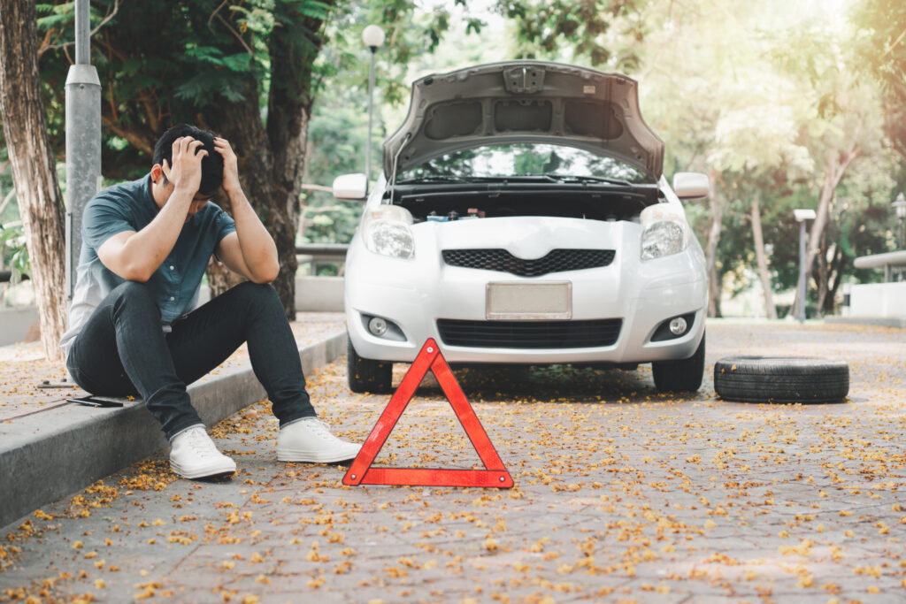 vecteezy_asian-woman-sitting-beside-car-after-a-car-breakdown-on_21780713