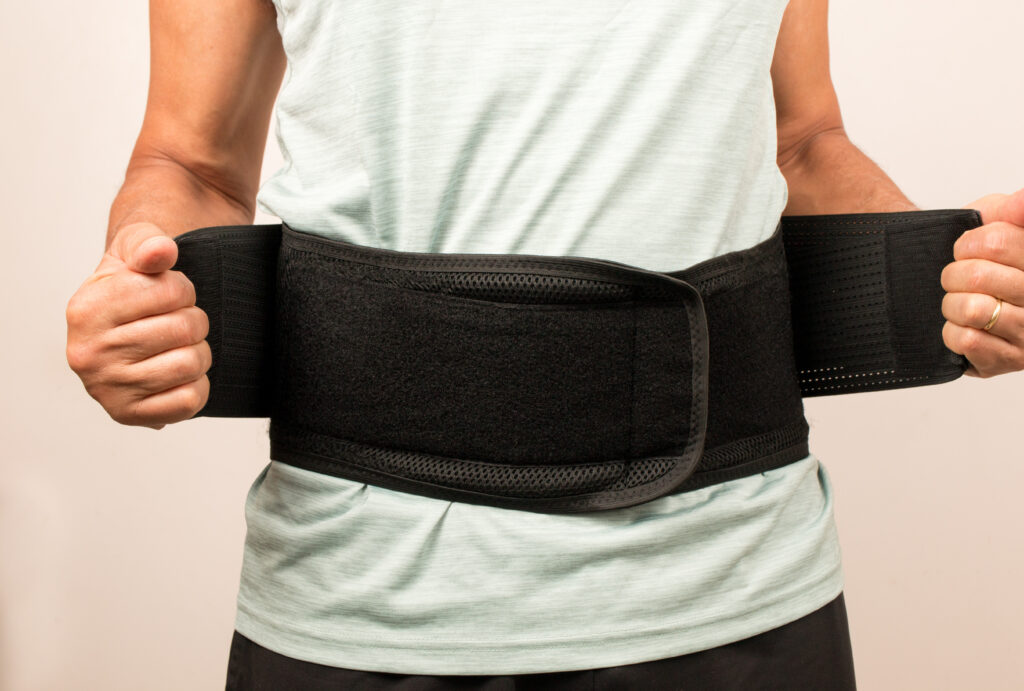 vecteezy_man-wearing-a-back-brace-for-his-injured-back-back-pain_4533975